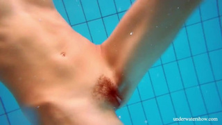 Ravishing red-head hairy snatch underwater
